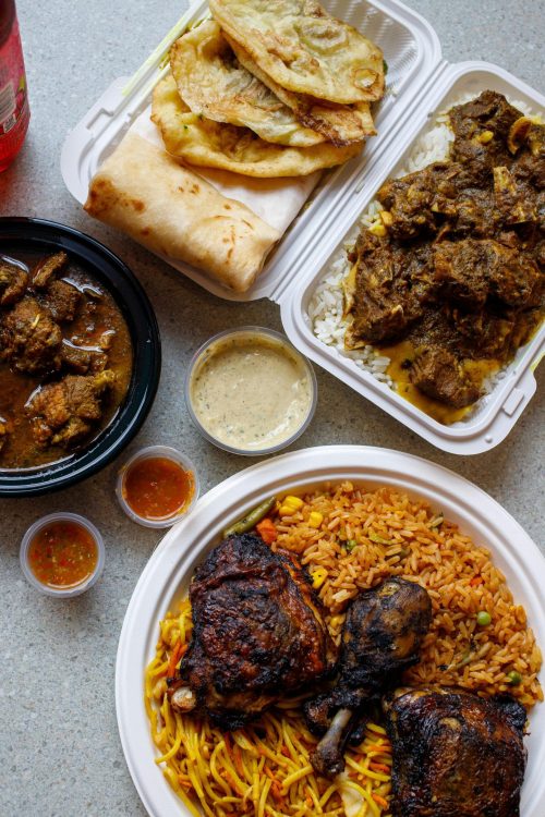 pexels-photo-30246915-30246915 An appetizing assortment of traditional African foods including rice, meats, and sauces on a table.