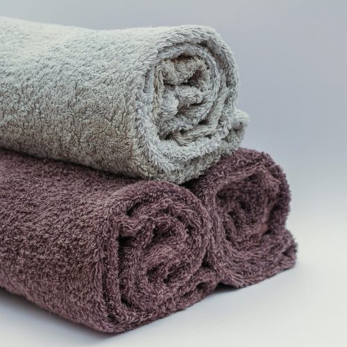 pexels-photo-45980-45980 Close-up of rolled bathroom towels in neutral tones, ideal for interior design or spa themes.